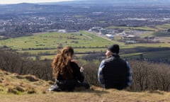 Man and woman seen from the back with the racecourse in the distance