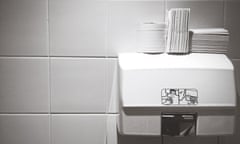 Close-Up Of Tissue Papers On Hand Dryers Against Tile Wall<br>GettyImages-667779517