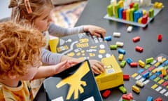Young girl with vision impairment touching the embossing on the Lego Braille Bricks