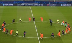 Paris Saint-Germain and Istanbul Basaksehir players take a knee