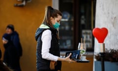 A waiter wearing a face mask is seen in the Old Town of Warsaw, Poland.