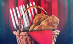 A promotional shot of a basket containing challah bread and a menorah