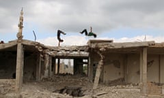Parkour coach Ibrahim al-Kadiri (R), 19, and Muhannad al-Kadiri, 18, demonstrate their Parkour skills amid damaged buildings