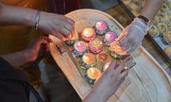 Saman and Dimple light candles as part of Diwali celebrations, Harris Park, 2022