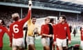 Gordon Banks (centre) and Bobby Moore (left) hoist the World Cup trophy, Wembley, 1966. (L-R) England captain Bobby Moore tries to retrieve the Jules Rimet trophy from goalkeeper Gordon Banks, watched by teammates Roger Hunt and Martin Peters ... England v West Germany - 1966 World Cup Final - Wembley Stadium ... 30-07-1966 ... NULL ... NULL ... Photo credit should read: S&G/S&G and Barratts/EMPICS Sport. Unique Reference No. 509839 ... NULL