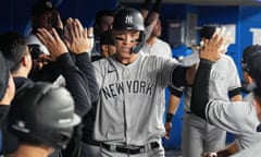 Aaron Judge celebrates in the dugout after hitting a home run against the Toronto Blue Jays on Monday