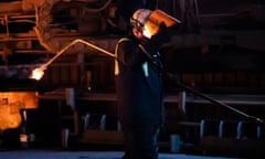 Man wearing helmet holding piece of metal