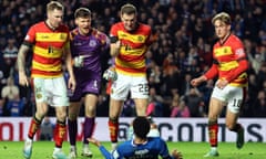 Rangers' Malik Tillman is pushed over by Partick Thistle players after scoring his side's second goal.