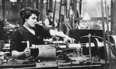 A female worker operating a machine in an armaments factory, circa 1915.