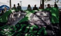 The relatives of British journalist Dom Phillips and activists hold a large banner with his image and that of Indigenous activist Bruno Pereira, with the Portuguese message: "Justice for Dom and Bruno" during the one-year anniversary commemoration since their murders, in Rio de Janeiro, Brazil, Monday, June 5, 2023. The two were were killed in the Amazon's Vale do Javari area. (AP Photo/Bruna Prado)