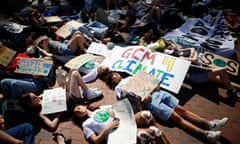 young people lying on the ground with signs