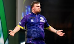 Luke Littler gestures to the crowd during his semi-final win over Rob Cross.