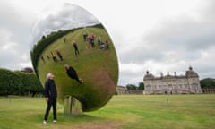 Artist Anish Kapoor looks into his sculpture Sky Mirror’ at Houghton Hall, King’s Lynn, ahead of the opening of his largest UK exhibition of outdoor sculptures.