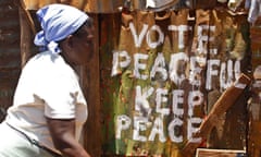 Woman walks past message of peace in Kibera, Nairobi