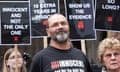 Andrew Malkinson outside the Royal Courts of Justice  flanked by supporters carrying plackards, one of which reads ‘Innocent and not the only one’