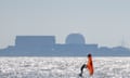 A windsurfer sails in front of the Sizewell B nuclear power plant in Suffolk, England