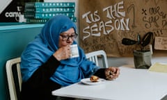 Hosna, a volunteer at the Canvas, has a drink at the cafe which gives free meals to refugees and the homeless.