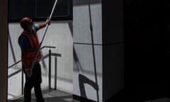 A cleaner is seen working in a shopping mall in Sydney