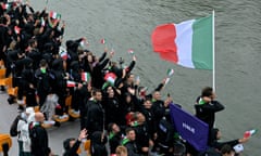 Gianmarco Tamberi with the Italian flag during his team’s boat trip down the River Seine.