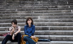 Luana Giuliani and Penélope Cruz sitting on old stone steps in L’immensità