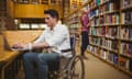 Young man in wheelchair working on laptop