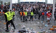 Stewards replace barricades after they were knocked over by supporters outside Wembley on the day of the Euro 2020 final between England and Italy.