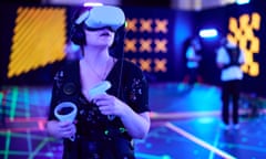 A visitor wearing a VR headset and using controllers