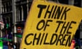 Students protest in central London against an increase in university tuition fees. The sign reads 'think of the children'