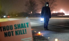 An anti-death penalty advocate protests the execution of Dustin Higgs, outside the United States penitentiary in Terre Haute, Indiana.