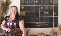 Anna Matilda poses in front of the piece she made in 2007 from culinary seed.