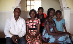 Friday Sani, left, with his daughters Rejoice, second left, and Victory, second right, who were among 39 students kidnapped from their college. 