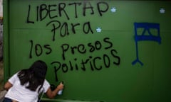 A woman spray-paints ‘Freedom for political prisoners’ in Managua, Nicaragua, in 2020.