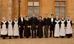 Downton Abbey cast members lined up in a row outside the house