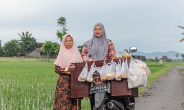 Giyem, left, and her daughter Retno Sri Mulatsih with her jamu cart in Sukoharjo Regency, Central Java, Indonesia