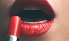 Close up of woman applying red lipstick