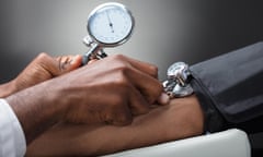 Close-up of a doctor measuring a patient's blood pressure.
