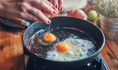 Two eggs frying in a pan.