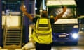 A member of the Border Agency stops a lorry for checks