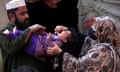 A health worker administers polio vaccine drops to a child during a door-to-door vaccination campaign in Peshawar, Pakistan.