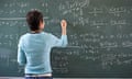 Teacher Writing Maths Problem on Blackboard