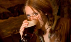 A woman drinking a pint of bitter.