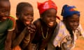 Group of young children smiling paddling in the Niger River Mali