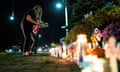 A woman place flowers during a candlelight vigil for Gabby Petito.