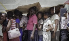 TOPSHOTS Haitians wait in line near St. Luke's Family hospital for a consultation in Tabarre, on September 17, 2015, from American doctors from USNS Comfort, a US Navy seagoing Medical Treatment Facility. Since April, the U.S. Southern Command hospital ship has taken a team of U.S. military medical and construction personnel, private-aid organizations and partner-nation officials to 11 Latin American and Caribbean nations, treating more than 100,000 patients and performing community-assistance projects. 