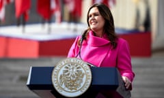 A woman smiles from behind a lectern