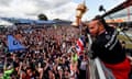 Lewis Hamilton shows off his winner’s trophy to the fans at Silverstone after his record 9th British Grand Prix victory.