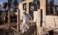 The Rev Ai Hironaka, resident minister of the Lahaina Hongwanji Mission, walks out of a destroyed building