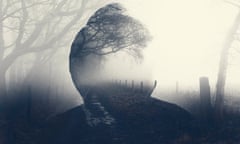 A double exposure of a spooky half transparent hooded figure. Over layered over a foggy path in the countryside. On a moody foggy winters day.