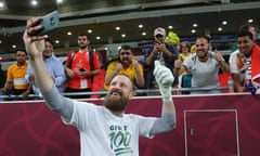 Goalkeeper Andrew Redmayne poses for a selfie with fans after the Socceroos won the World Cup 2022 inter-confederation playoff against Peru.