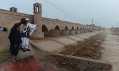 People look at flood waters in Guzara district,Herat province, Afghanistan